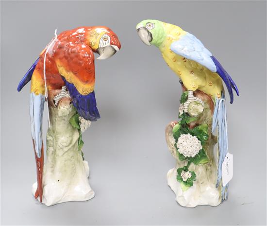 A pair of Sitzendorf Macaws, one red, one blue, H 30cm approx